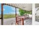 Covered porch with railings and a view of a park with a pond at 8509 Colorado Ct, Denver, CO 80229