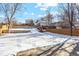 Snowy backyard with wooden fence and shed at 4140 S Inca St, Englewood, CO 80110