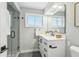 Clean bathroom with a white vanity, glass shower, and neutral colors at 4140 S Inca St, Englewood, CO 80110