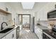 Bright kitchen features white cabinets, gray countertops, and a view to the dining area at 4140 S Inca St, Englewood, CO 80110