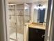 Bathroom featuring a tile shower, stylish vanity, and a well-lit mirror, showcasing a modern and clean design at 8146 E Harvard Cir, Denver, CO 80231