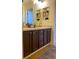 Well-lit bathroom showcasing a double sink vanity with gold fixtures and ample storage space at 8146 E Harvard Cir, Denver, CO 80231