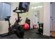 Home exercise area complete with Peloton bike, fitness equipment, and a mirrored wall for a motivating workout space at 8146 E Harvard Cir, Denver, CO 80231