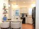 Well-lit kitchen with granite countertops, pendant lights, tile floors, and stainless steel appliances at 8146 E Harvard Cir, Denver, CO 80231