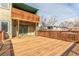 Spacious wooden backyard deck with an upper-level covered patio, perfect for relaxing and entertaining outdoors at 6758 W Louisiana Pl, Lakewood, CO 80232