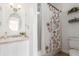 Bathroom featuring patterned tile flooring, neutral colored walls, and floral shower curtain at 6758 W Louisiana Pl, Lakewood, CO 80232