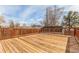 Large wood deck with wooden railings offering backyard views, perfect for outdoor gatherings and relaxation at 6758 W Louisiana Pl, Lakewood, CO 80232