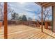 Spacious wooden deck with natural wood railings offering an excellent outdoor living and entertaining space at 6758 W Louisiana Pl, Lakewood, CO 80232