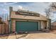 Charming home featuring a two-car garage, brick accents, dormer windows, and well-maintained landscaping at 6758 W Louisiana Pl, Lakewood, CO 80232