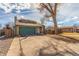 Suburban house featuring a wide driveway, a two-car garage, dormer windows, and a well-kept yard at 6758 W Louisiana Pl, Lakewood, CO 80232