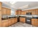 Spacious kitchen featuring granite countertops and oak cabinetry at 6758 W Louisiana Pl, Lakewood, CO 80232