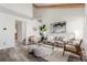 Bright living room with vaulted ceilings, exposed wood beams, stylish furnishings, and a modern aesthetic at 6758 W Louisiana Pl, Lakewood, CO 80232