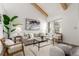 Sunlit living area featuring neutral decor, comfortable seating, large windows, and contemporary design elements at 6758 W Louisiana Pl, Lakewood, CO 80232