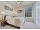 Cozy bedroom featuring a comfortable bed, side table, window with blinds, and stylish decor at 8054 E 152Nd Dr, Thornton, CO 80602