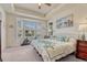 Bedroom with tray ceilings, bay window views, and exercise equipment at 8054 E 152Nd Dr, Thornton, CO 80602