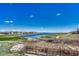 Picturesque community view with a lake and lush green spaces and golf course at 8054 E 152Nd Dr, Thornton, CO 80602