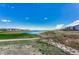 Picturesque community view with a lake and lush green spaces and golf course at 8054 E 152Nd Dr, Thornton, CO 80602