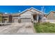 Charming home with a three-car garage, inviting entryway, and well-maintained lawn on a sunny day at 8054 E 152Nd Dr, Thornton, CO 80602