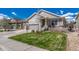 Attractive home with a three-car garage, green lawn, and manicured landscaping at 8054 E 152Nd Dr, Thornton, CO 80602
