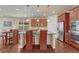 Bright kitchen with stainless appliances, granite countertops, eat-in island and hardwood floors at 8054 E 152Nd Dr, Thornton, CO 80602