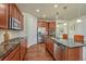 Well-equipped kitchen with stainless steel appliances, granite countertops, and hardwood floors at 8054 E 152Nd Dr, Thornton, CO 80602