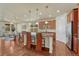 Open kitchen featuring a breakfast bar, stainless steel appliances, and hardwood floors at 8054 E 152Nd Dr, Thornton, CO 80602