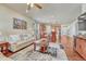 Bright, open living room with hardwood floors, connecting seamlessly to the modern kitchen and dining at 8054 E 152Nd Dr, Thornton, CO 80602