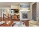 Comfortable living room with fireplace, stylish decor, hardwood floors, and plenty of natural light at 8054 E 152Nd Dr, Thornton, CO 80602