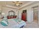 Main bedroom with tray ceilings, a full dresser and closet, and a glimpse into the main bath at 8054 E 152Nd Dr, Thornton, CO 80602