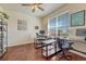 Bright office space featuring wood floors, a ceiling fan, and two workstations by a large window at 8054 E 152Nd Dr, Thornton, CO 80602
