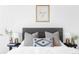 Stylish bed with gray headboard, neutral pillows, and bedside tables at 3408 W 17Th Ave, Denver, CO 80204