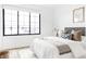 Bright bedroom with a large window, neutral tones, and plush bedding at 3408 W 17Th Ave, Denver, CO 80204