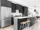 Modern kitchen with dark cabinetry, stainless steel appliances and island at 3408 W 17Th Ave, Denver, CO 80204