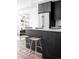 Modern kitchen island with white countertop and wood stools at 3408 W 17Th Ave, Denver, CO 80204