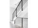 Modern staircase with sleek metal railing and hardwood floors at 3408 W 17Th Ave, Denver, CO 80204