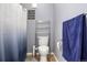 Small bathroom featuring a shower, toilet, and a cute decor at 5745 N Genoa Way # 306, Aurora, CO 80019