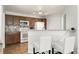 Bright kitchen with bar seating, tiled floors, a white range, and wooden cabinets at 5745 N Genoa Way # 306, Aurora, CO 80019