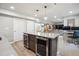 Finished basement with a wet bar with dual beverage coolers and an open living area with a desk at 4220 Quitman St, Denver, CO 80212