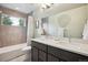 Bathroom featuring a double sink vanity, modern fixtures, a tiled shower and tub with a window at 4220 Quitman St, Denver, CO 80212