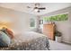 Cozy bedroom featuring multiple windows, a ceiling fan, dresser, and soft, neutral color palette at 4220 Quitman St, Denver, CO 80212