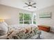 Bright bedroom with a large window overlooking lush greenery, ceiling fan, and charming wood chest at 4220 Quitman St, Denver, CO 80212