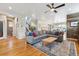 Open-concept living room showcasing hardwood floors, modern decor and a cozy sectional sofa at 4220 Quitman St, Denver, CO 80212