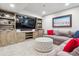Inviting living room area with built-in bookshelves, a large screen TV, and comfortable seating at 4220 Quitman St, Denver, CO 80212