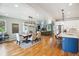 Open living space featuring a modern dining table, hardwood floors, and stainless steel appliances at 4220 Quitman St, Denver, CO 80212