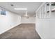 Open basement featuring clean white walls, neutral carpet, and ample lighting for a versatile living space at 12829 E Nevada Ave, Aurora, CO 80012