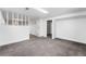 Spacious basement area with neutral carpet and bright white walls, ready for customization and comfort at 12829 E Nevada Ave, Aurora, CO 80012