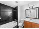 Stylish bathroom with dark tile, classic fixtures and wood vanity at 12829 E Nevada Ave, Aurora, CO 80012