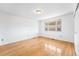 Bright bedroom features hardwood floors, a window, and neutral paint at 12829 E Nevada Ave, Aurora, CO 80012