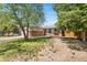 Attractive home boasting a brick facade, a spacious front yard, and mature trees at 12829 E Nevada Ave, Aurora, CO 80012
