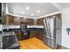 Functional kitchen featuring modern appliances, dark wooden cabinets, and solid surface countertops at 12829 E Nevada Ave, Aurora, CO 80012